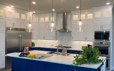 Redone kitchen with marble countertops and blue cabinet island